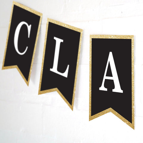 Celebrate graduation banner with a black background, white text (customizable) and gold glitter edging.